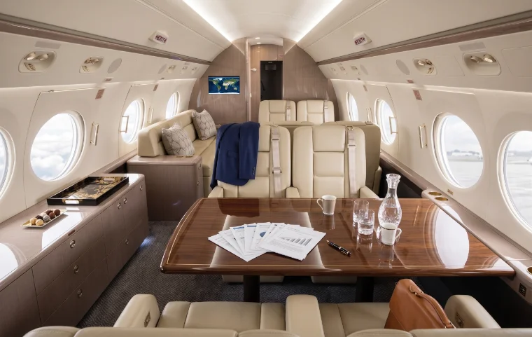 Large private jet cabin arranged as a working room